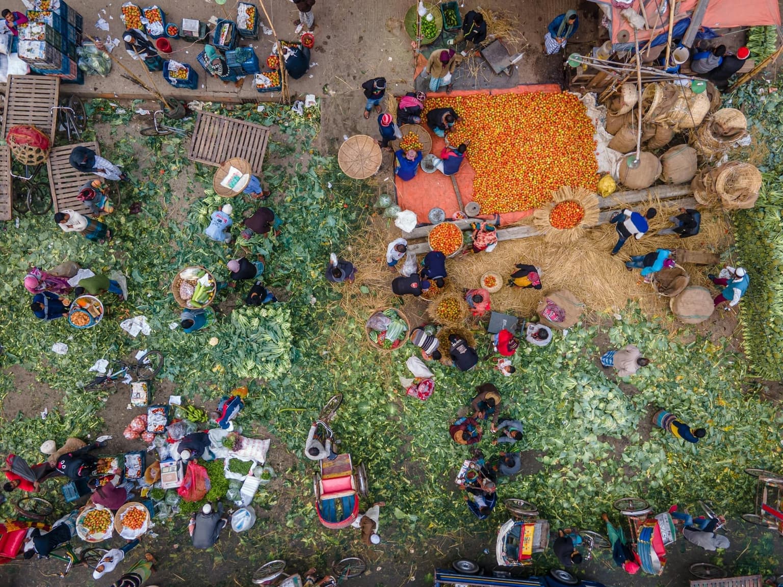Aerial view of a bustling outdoor vegetable market in rural Bangladesh.