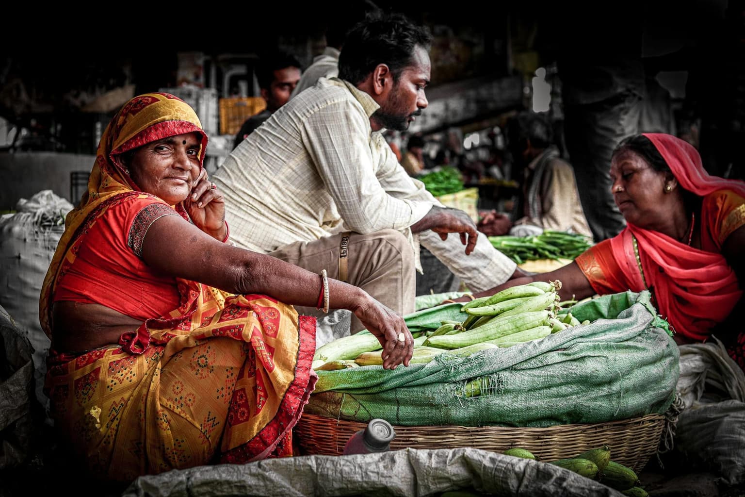 Women selling fresh vegetables at a subcontinental market.