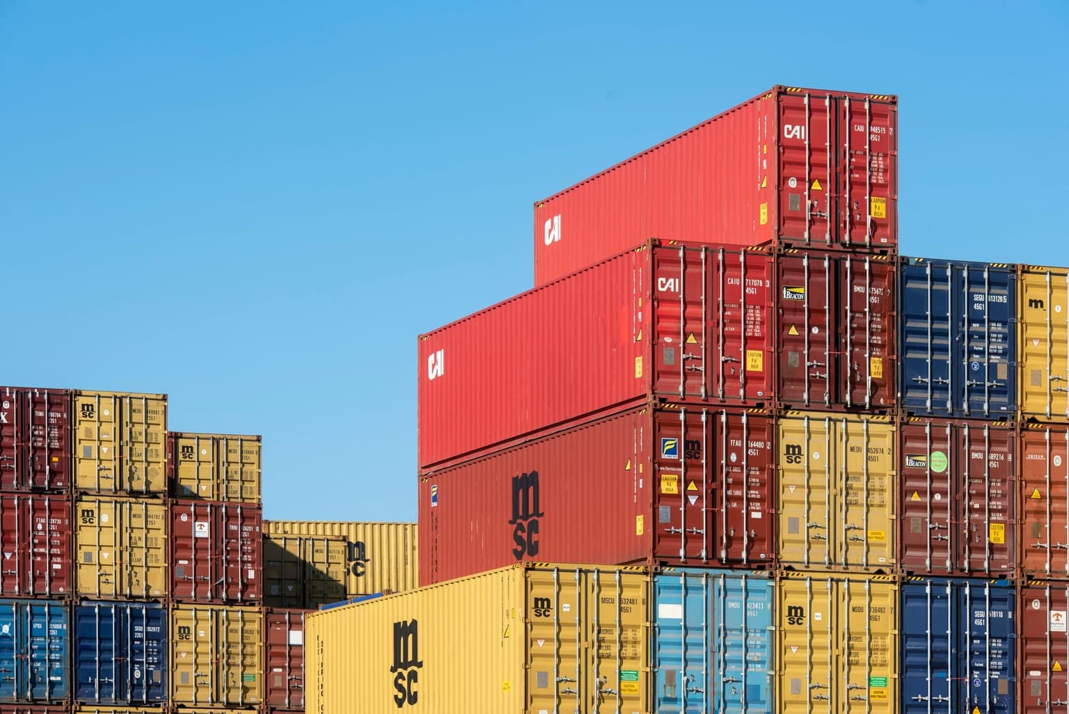 Stacked export shipping containers at a Chittagong port terminal